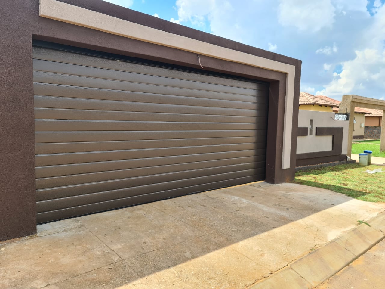 Bronze Aluzinc sectional garage door installed on a home